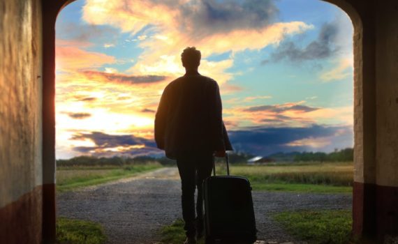 man holding luggage photo