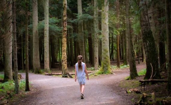 girl walking near trees