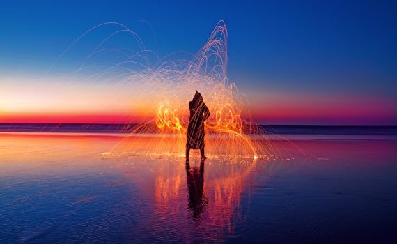 person with light effect surrounded with water